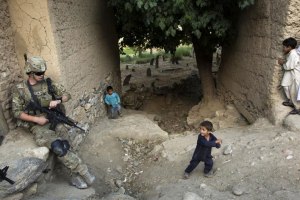 US Army infantry soldier protecting Afghan children