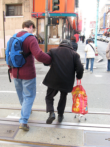 Helping an elderly lady cross a street
